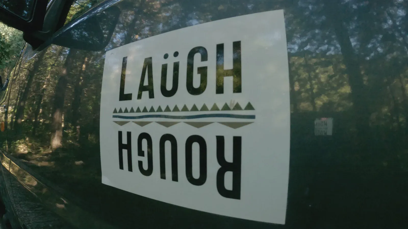 The Laugh & Rough logo on a Jimny door